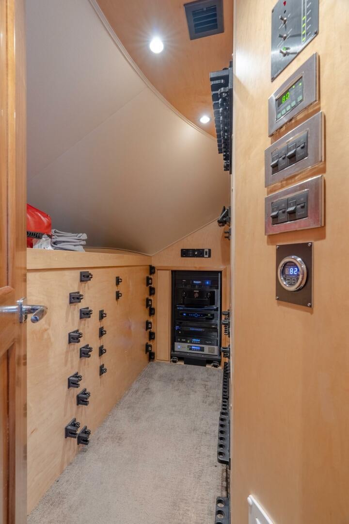 a room with a wood door and a wood cabinet with drawers aboard REEL CENTS Yacht for Sale