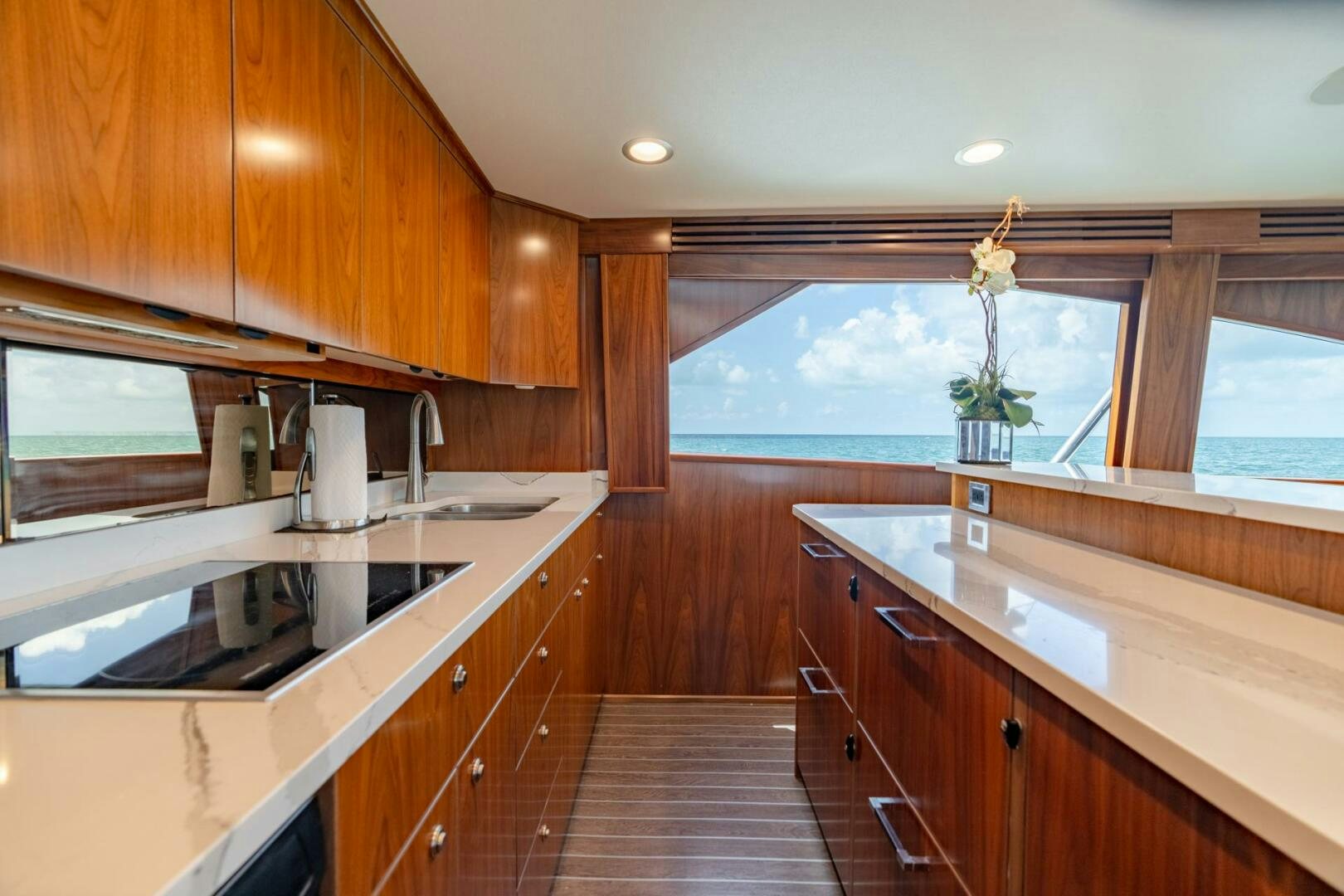 a kitchen with wooden cabinets aboard REEL CENTS Yacht for Sale