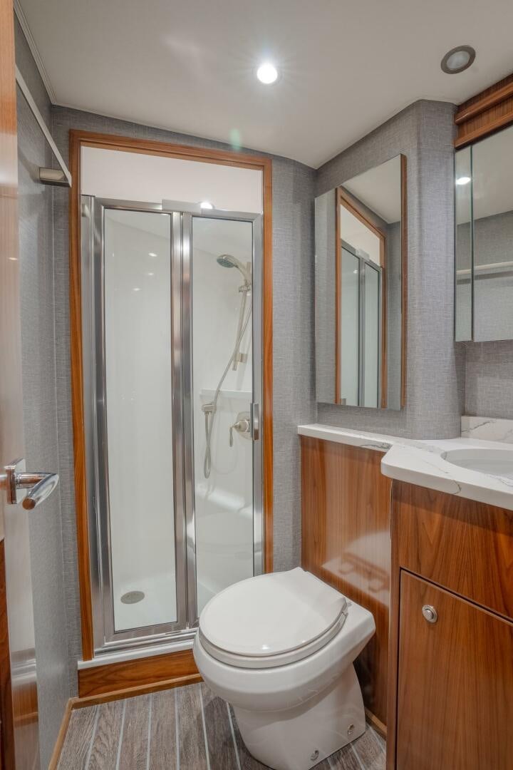 a bathroom with a glass shower door aboard REEL CENTS Yacht for Sale