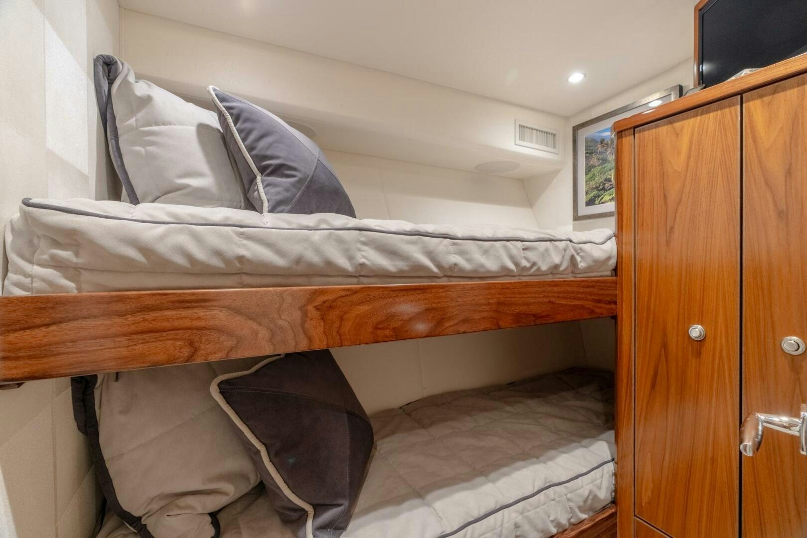 a bed with a wooden headboard aboard REEL CENTS Yacht for Sale
