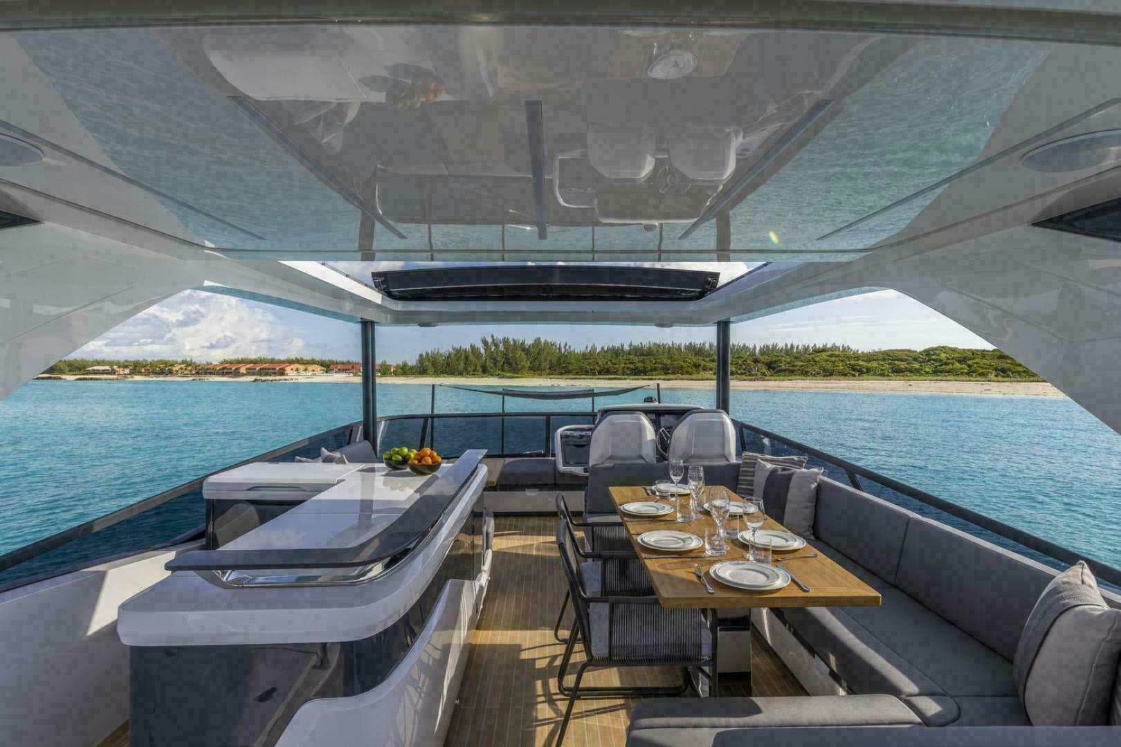 a table and chairs on a deck aboard NONE Yacht for Sale