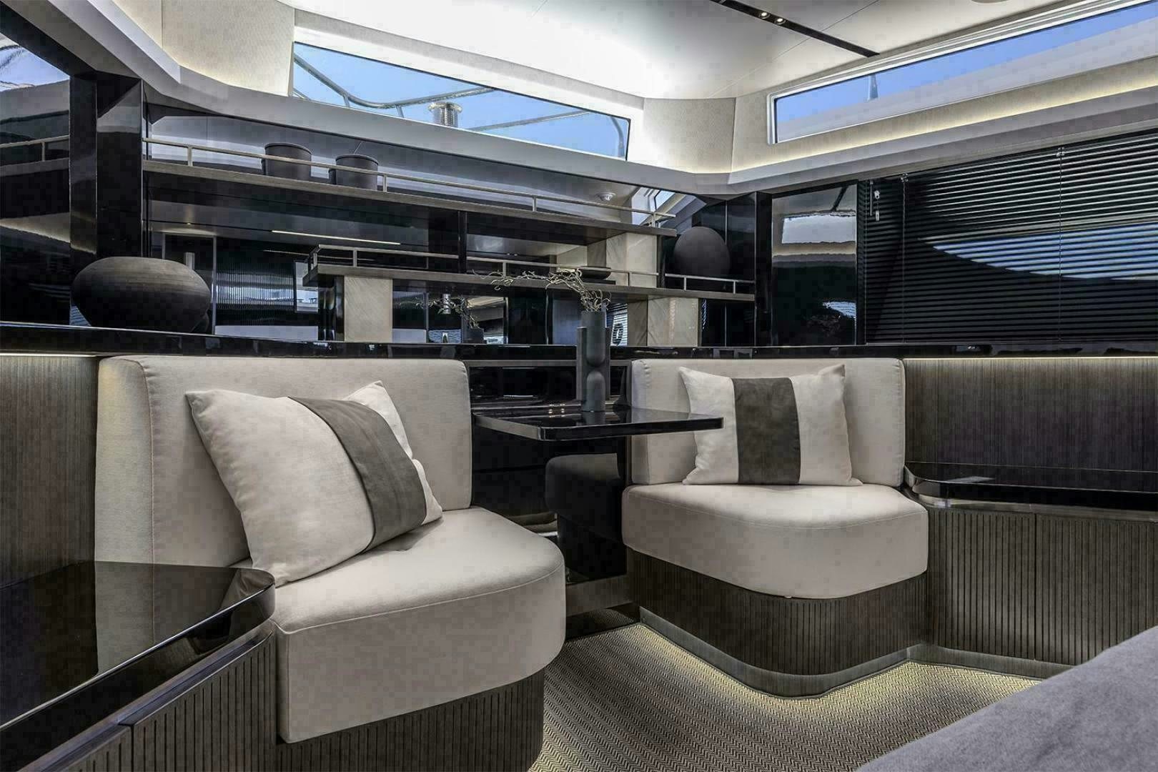 a room with couches and a table aboard NONE Yacht for Sale