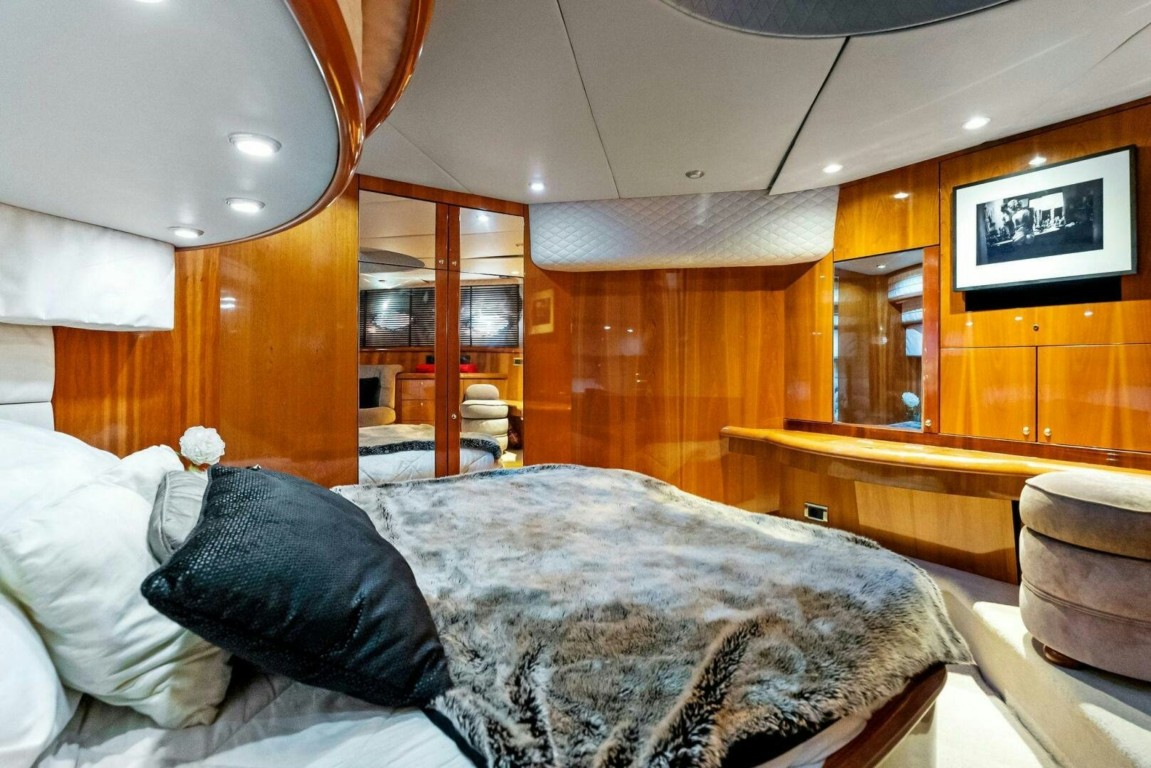 a bedroom with a bed and a desk aboard GAMBLER Yacht for Sale