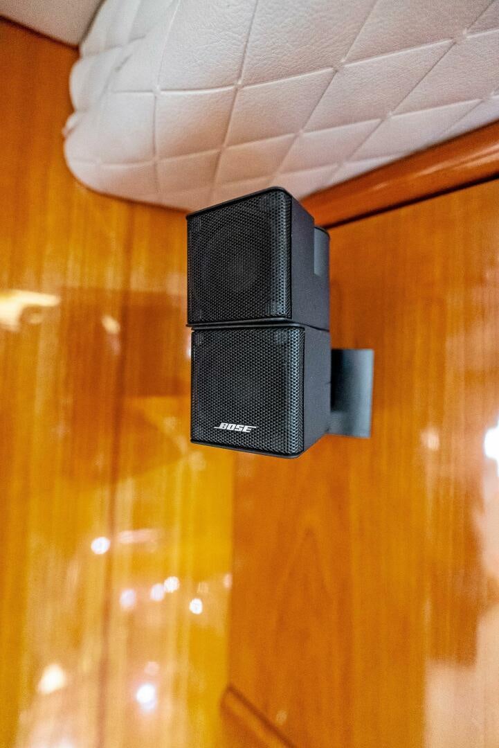 a black rectangular object on a wooden surface aboard GAMBLER Yacht for Sale