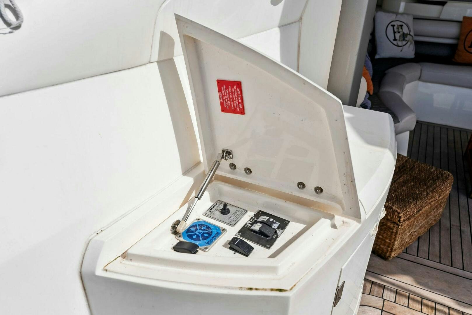 a white rectangular object with a red and blue label on it aboard GAMBLER Yacht for Sale