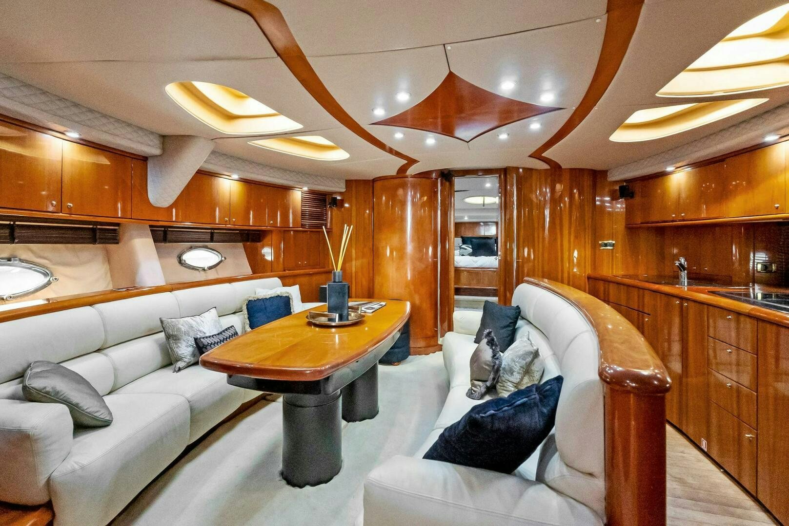 a living room with a couch and a table aboard GAMBLER Yacht for Sale