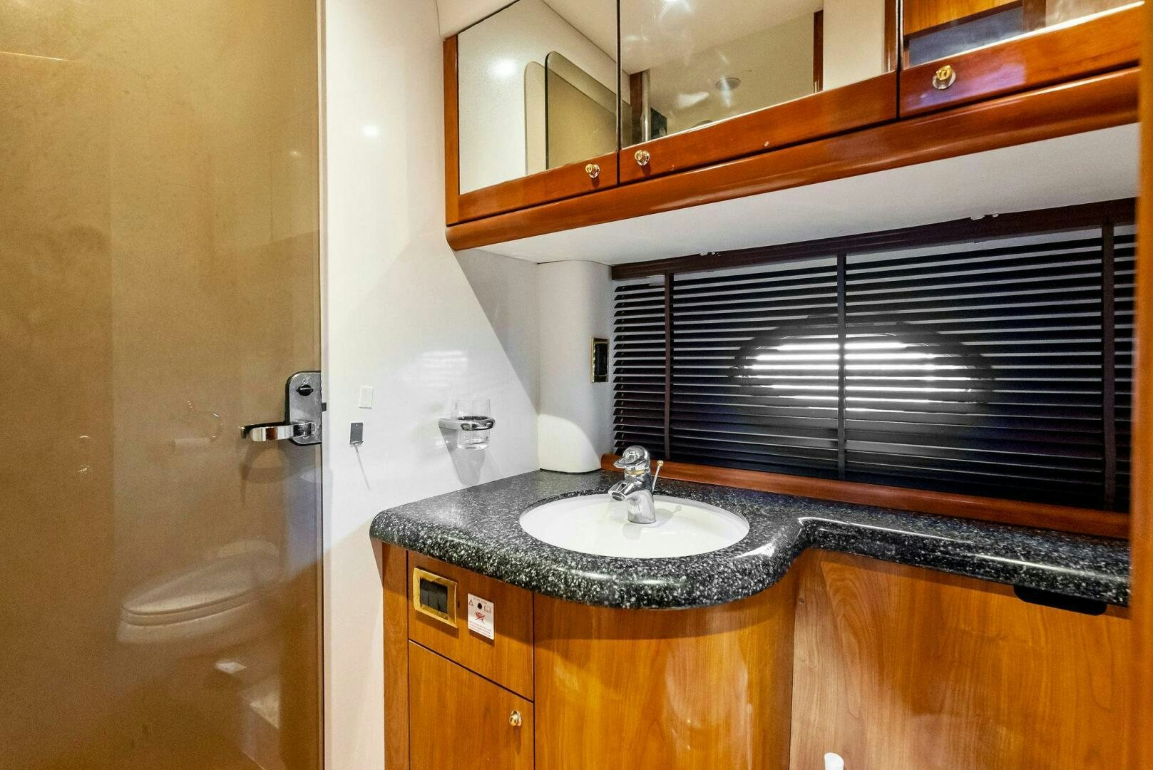 a bathroom with a sink and a mirror aboard GAMBLER Yacht for Sale