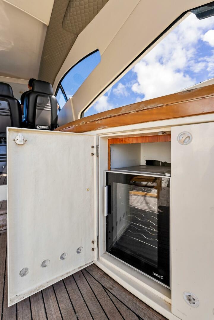 a white rectangular object with a glass door and a wood floor aboard GAMBLER Yacht for Sale