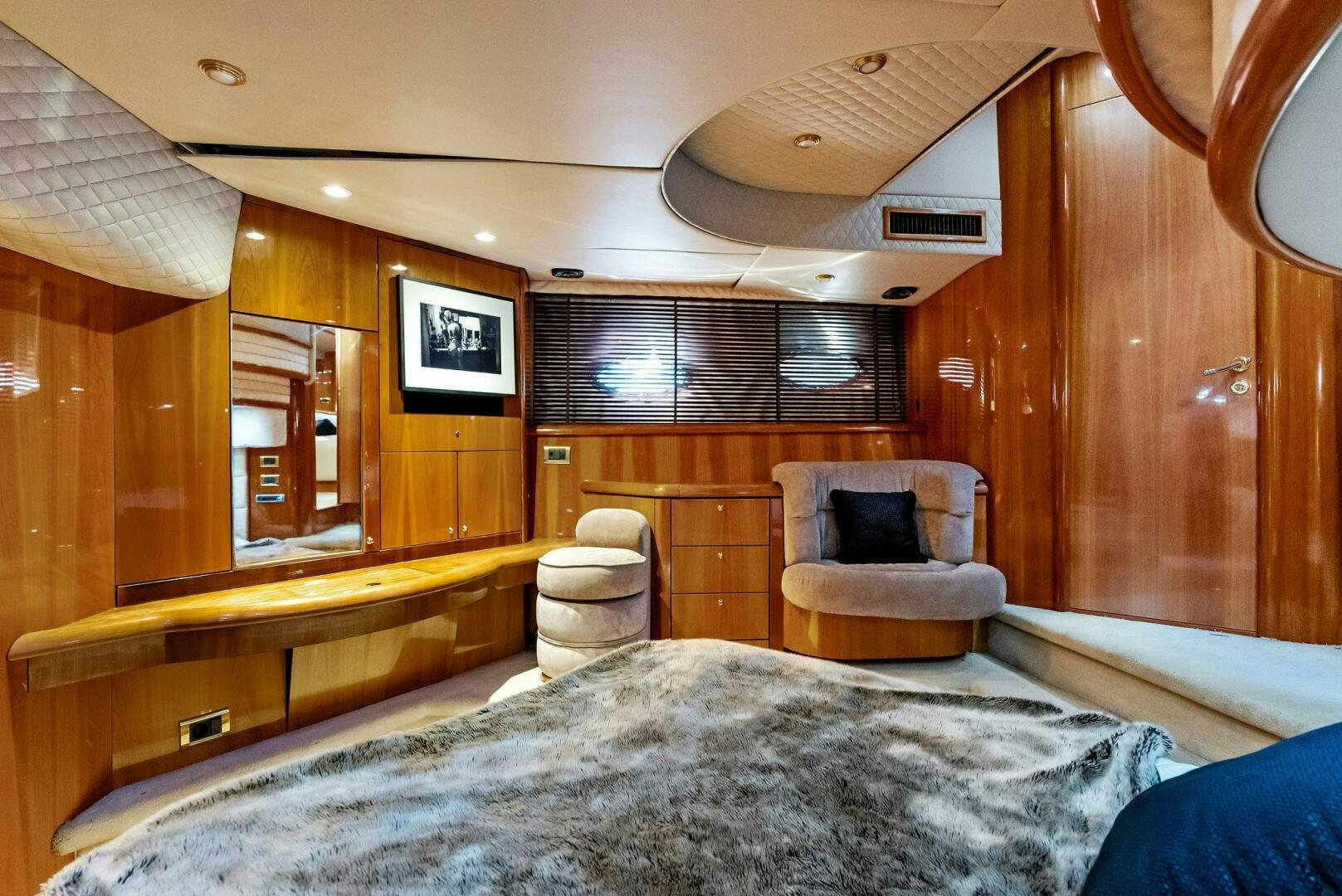 a bedroom with a bed and a chair aboard GAMBLER Yacht for Sale