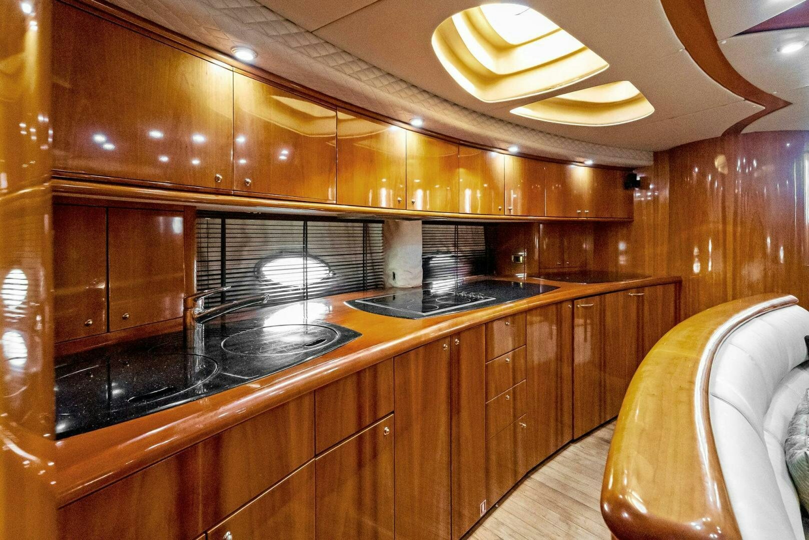 a kitchen with wooden cabinets aboard GAMBLER Yacht for Sale
