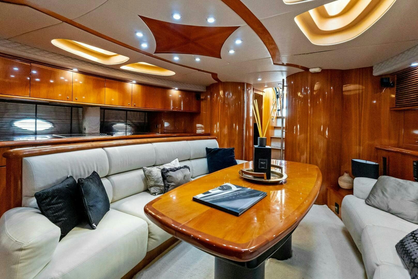a living room with a couch and a coffee table aboard GAMBLER Yacht for Sale