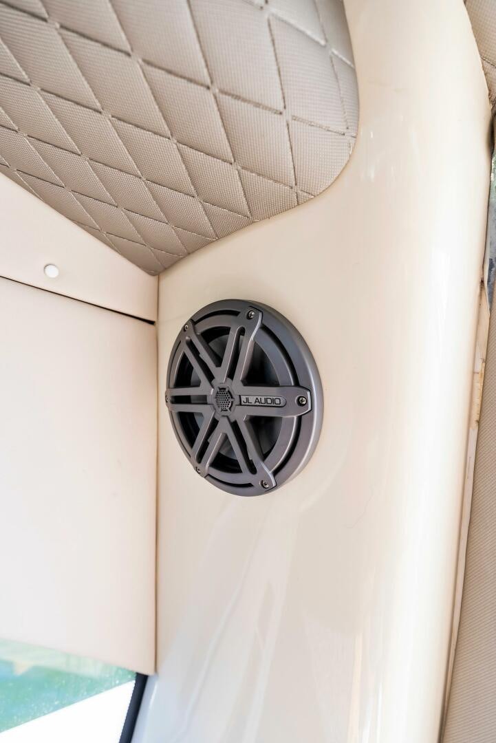 a white wall with a round black and silver clock on it aboard GAMBLER Yacht for Sale