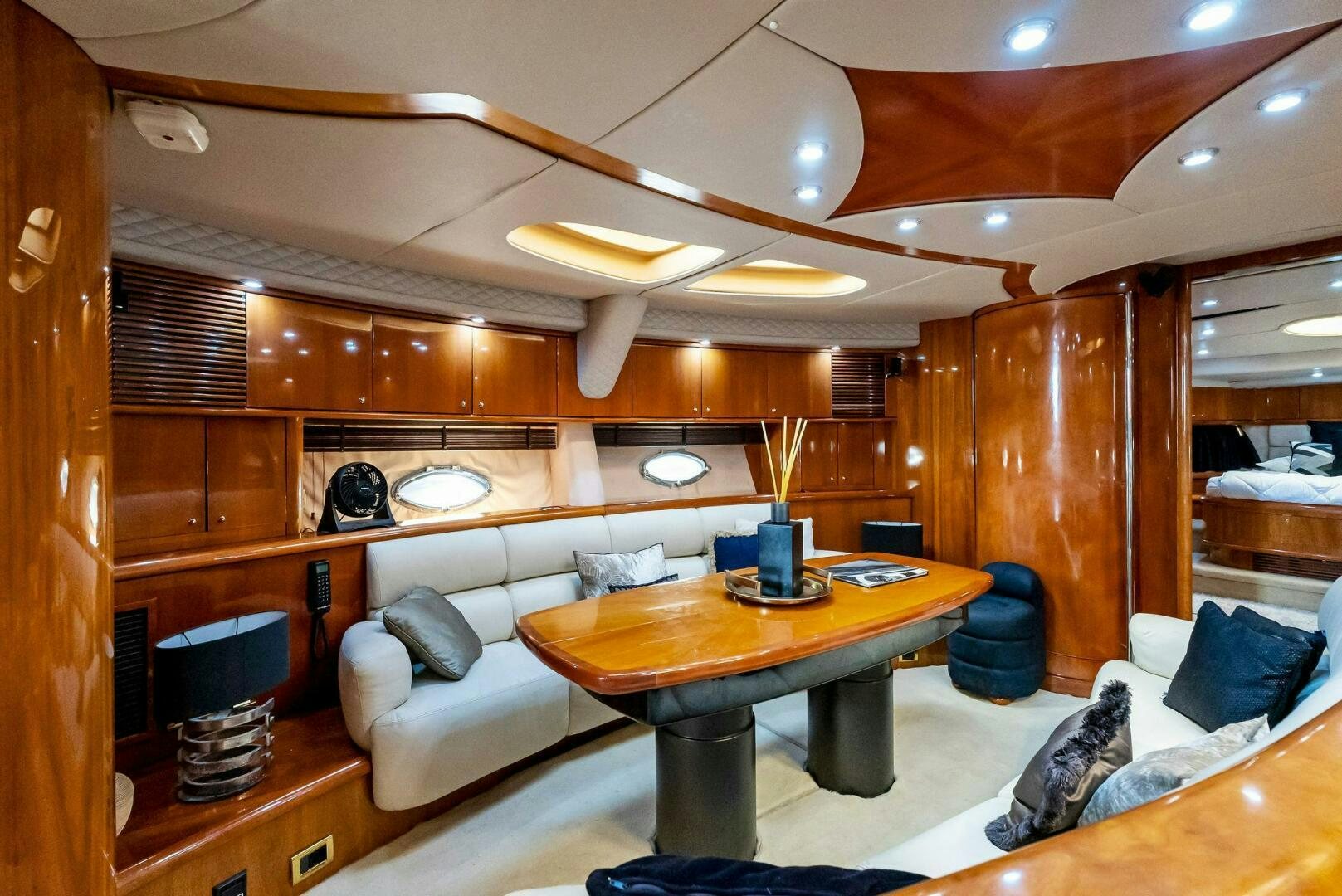 a living room with a couch and a table aboard GAMBLER Yacht for Sale