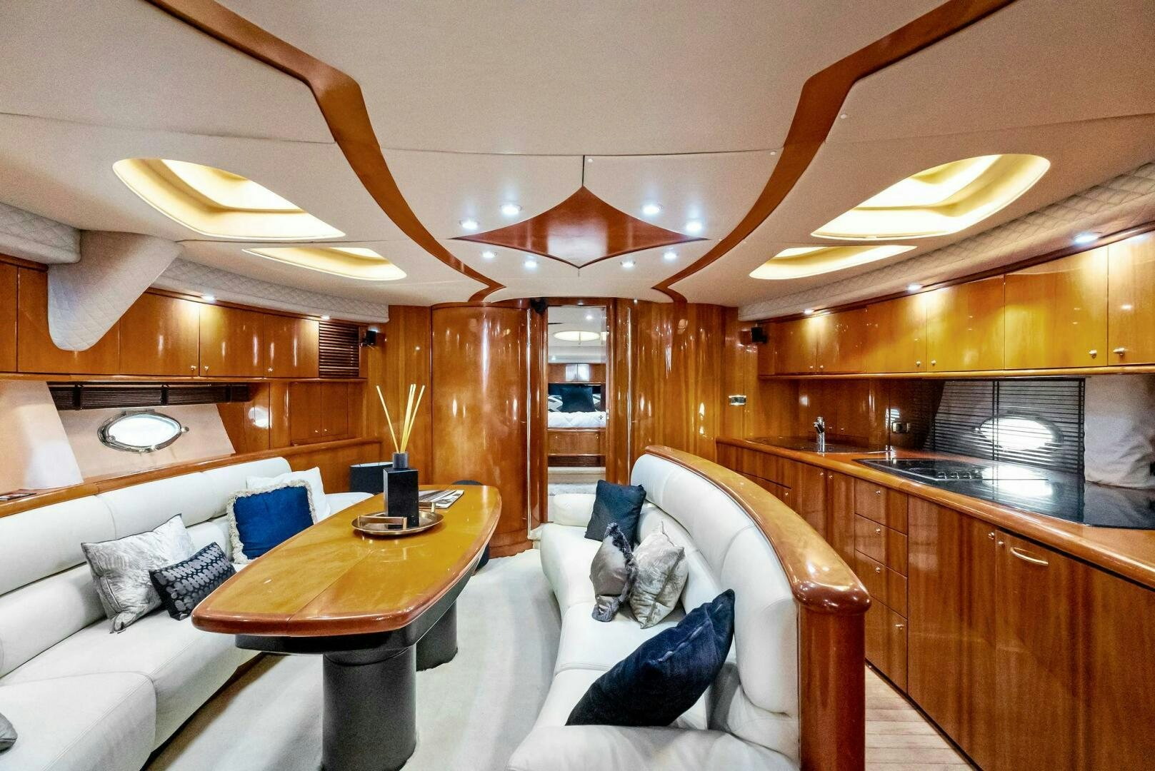 a living room with a couch and a table aboard GAMBLER Yacht for Sale