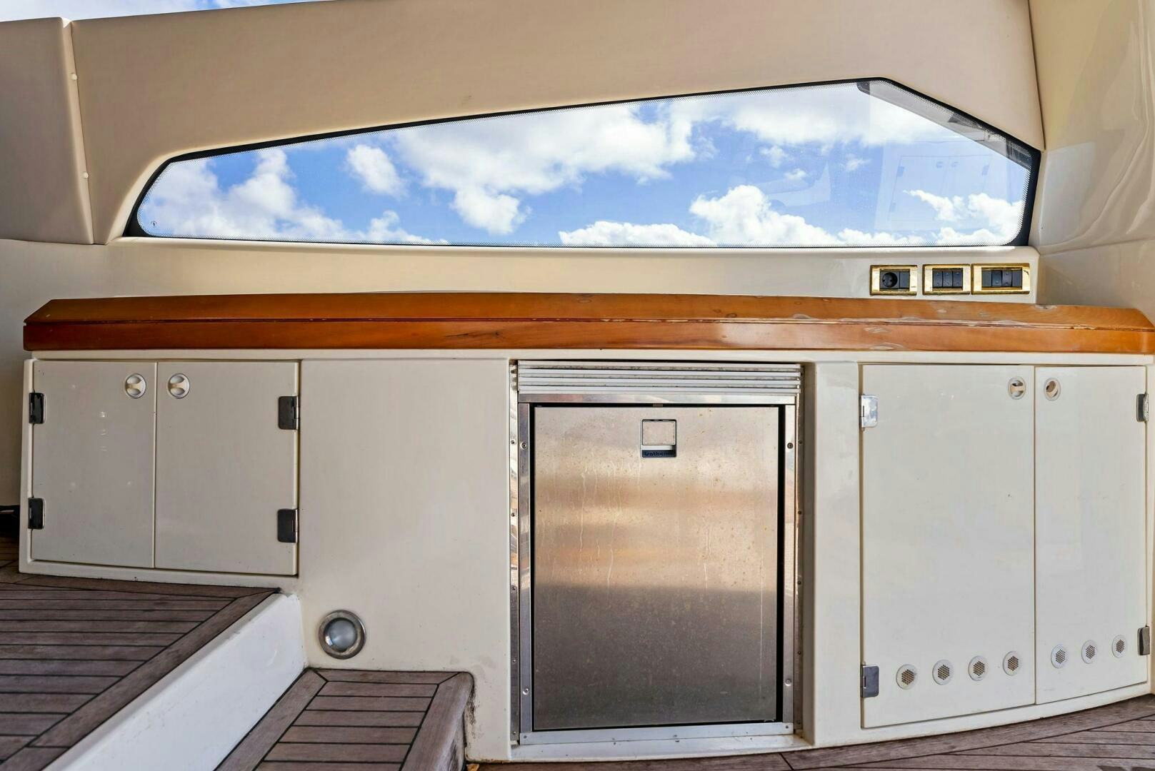 a large white cabinet with a glass door aboard GAMBLER Yacht for Sale