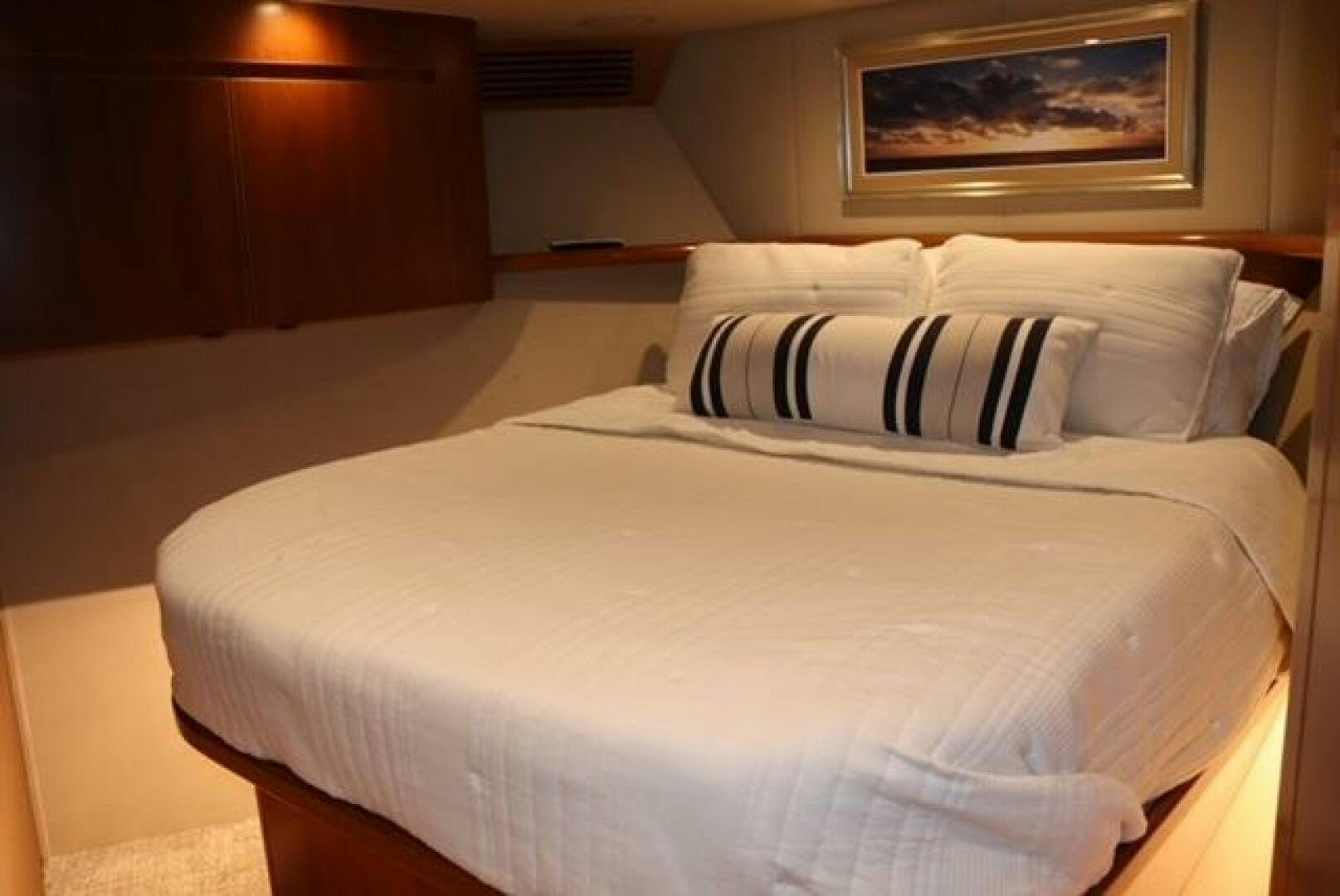 a bed with white sheets aboard BANDITO Yacht for Sale