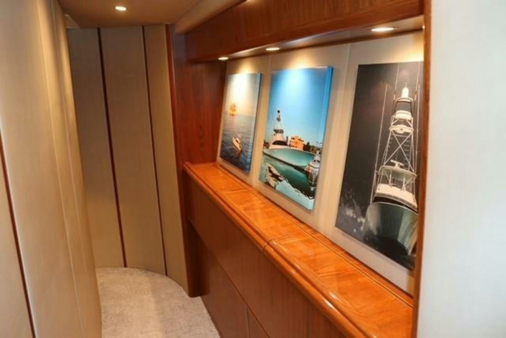 a large flat screen television on a wooden shelf aboard BANDITO Yacht for Sale