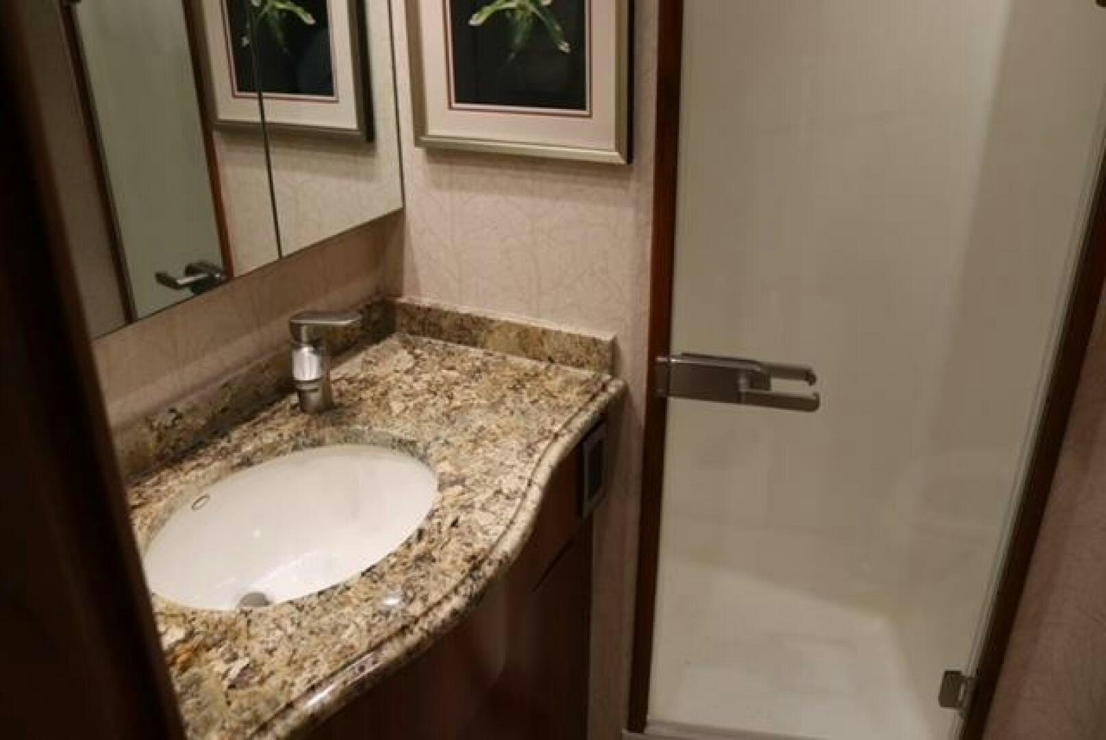 a bathroom with a sink and a mirror aboard BANDITO Yacht for Sale