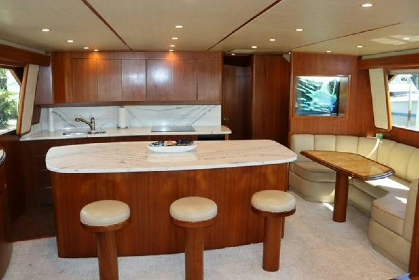 a kitchen with wooden cabinets aboard BANDITO Yacht for Sale