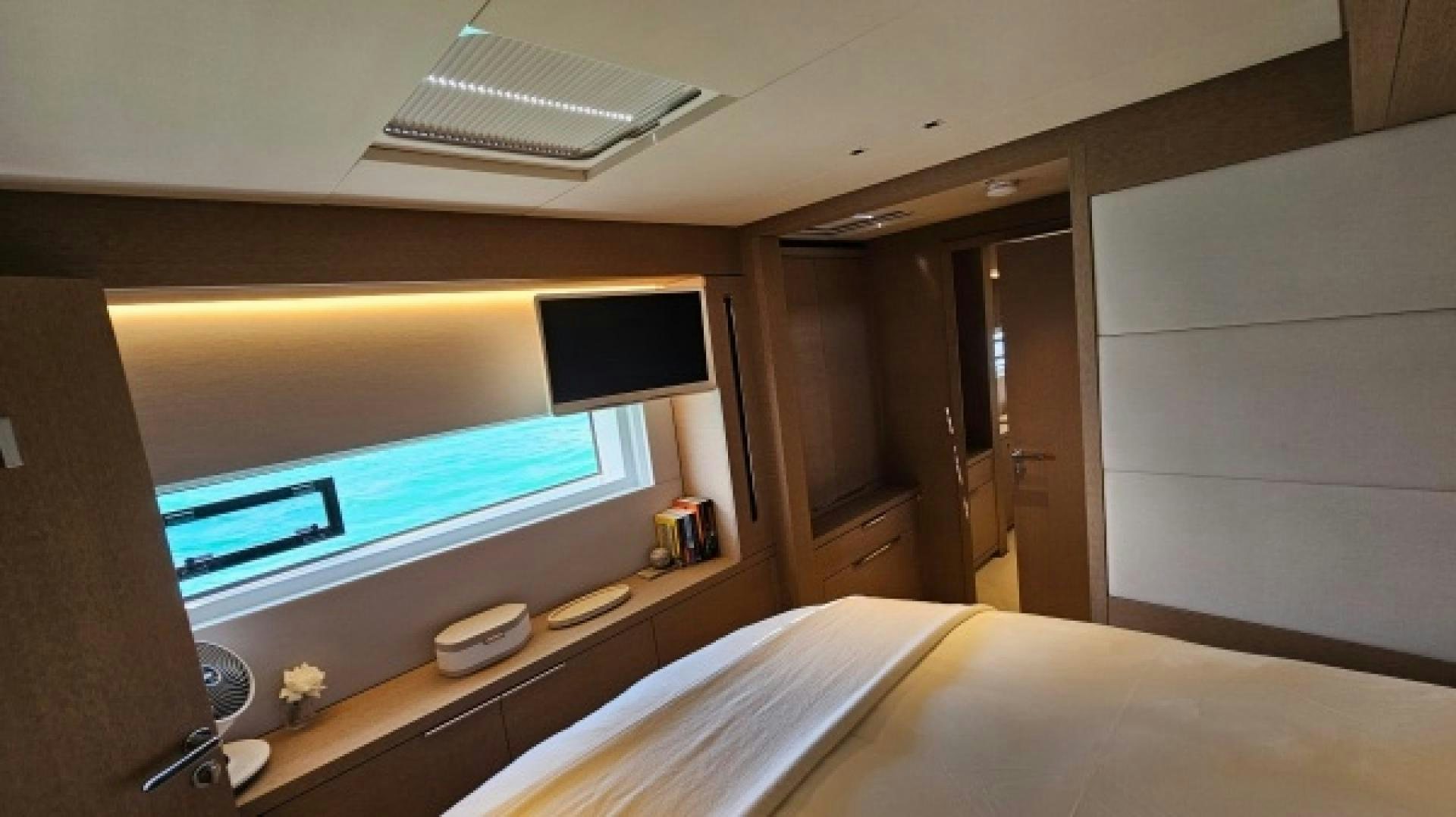 a room with a bed and a tv aboard SUNLOVE Yacht for Sale