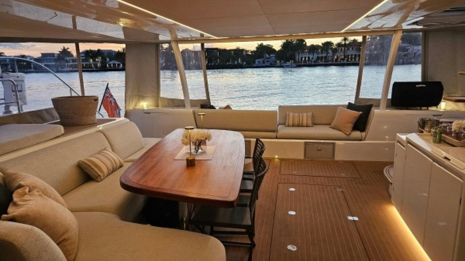 a room with a table and couches and a view of a city aboard SUNLOVE Yacht for Sale
