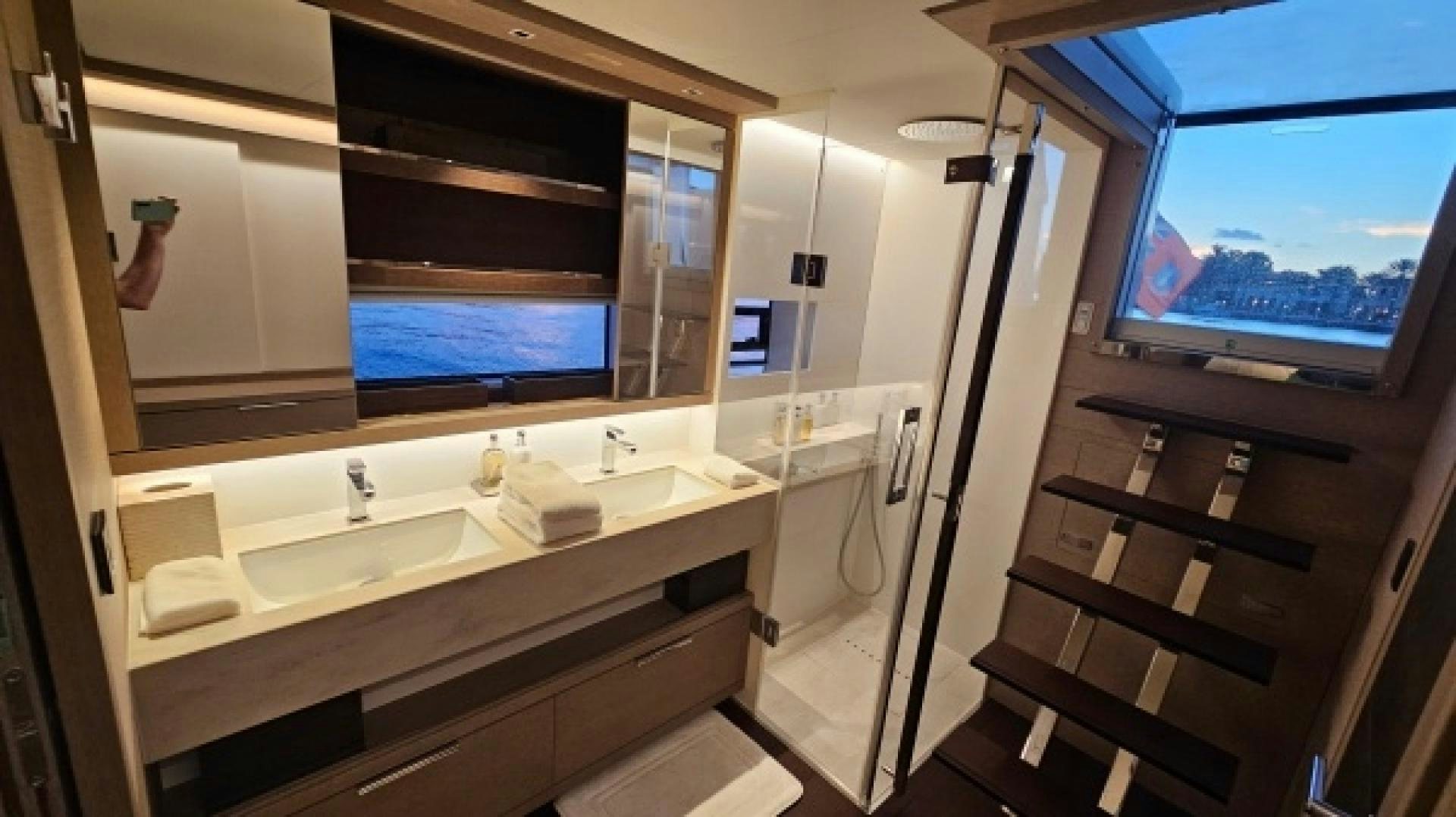 a bathroom with sinks and a large window aboard SUNLOVE Yacht for Sale