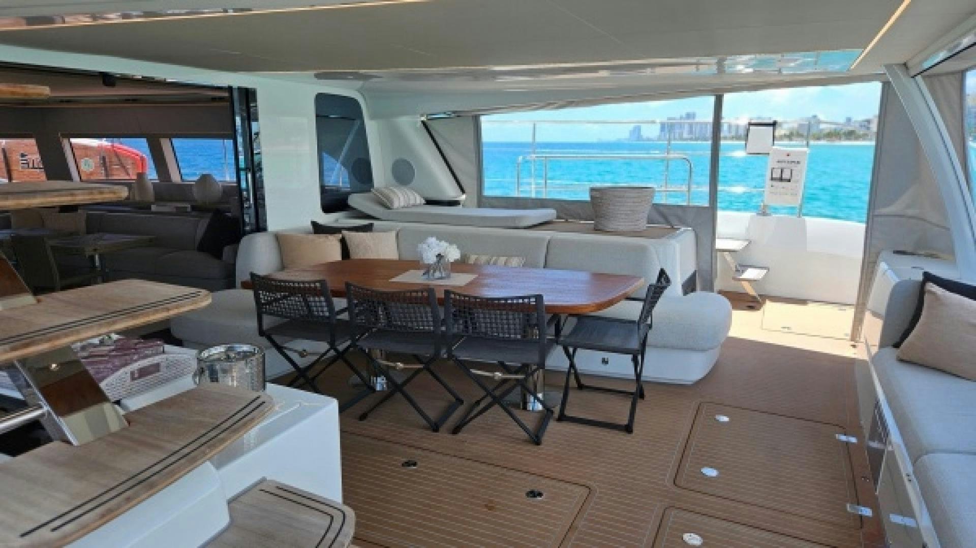 a room with a table and chairs aboard SUNLOVE Yacht for Sale