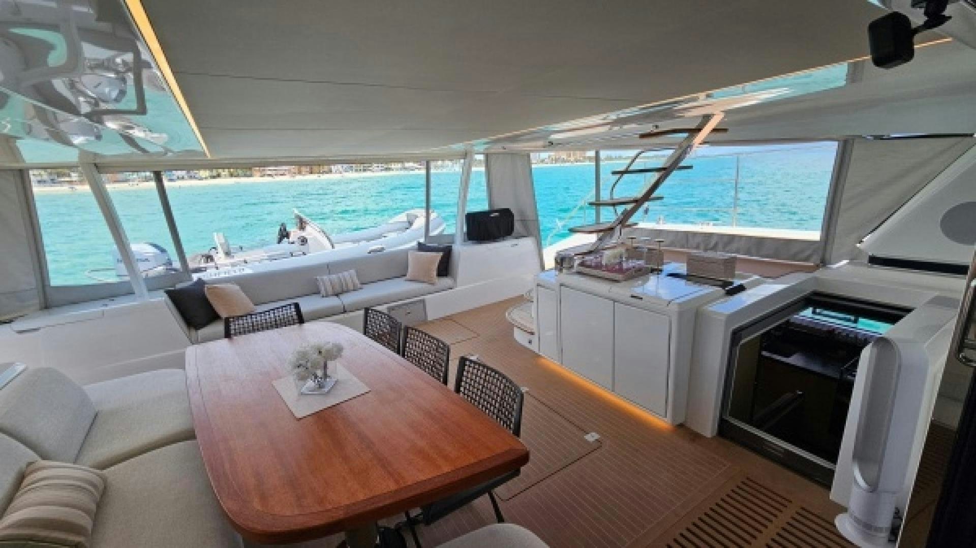 a room with a table and chairs aboard SUNLOVE Yacht for Sale