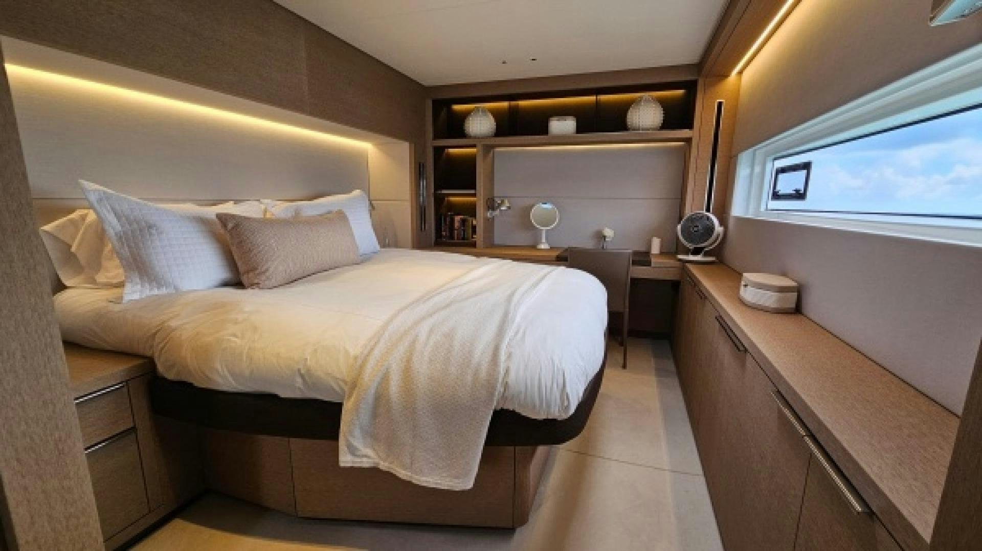 a bedroom with a bed and a desk aboard SUNLOVE Yacht for Sale