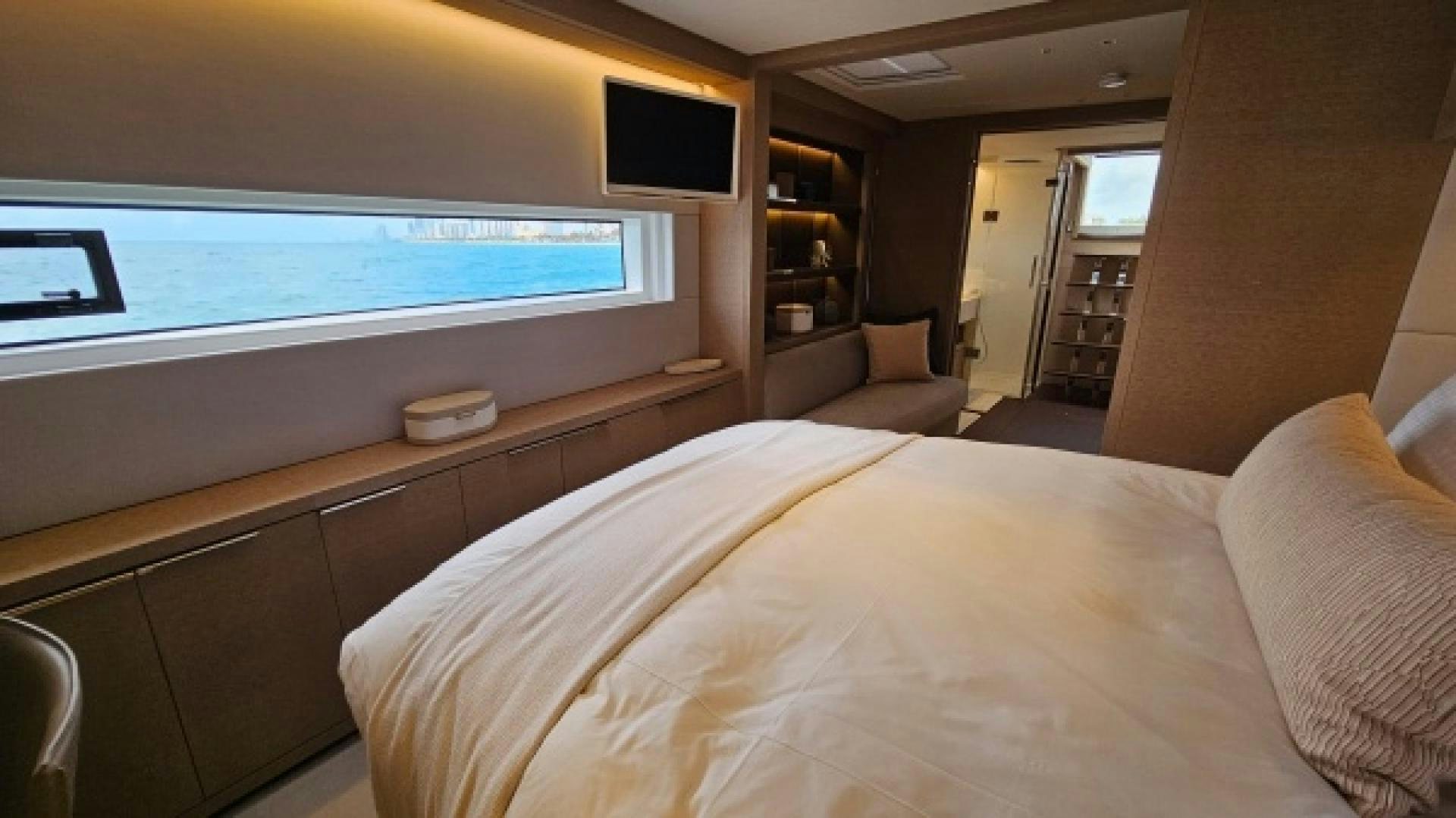 a room with a bed and a tv on the wall aboard SUNLOVE Yacht for Sale