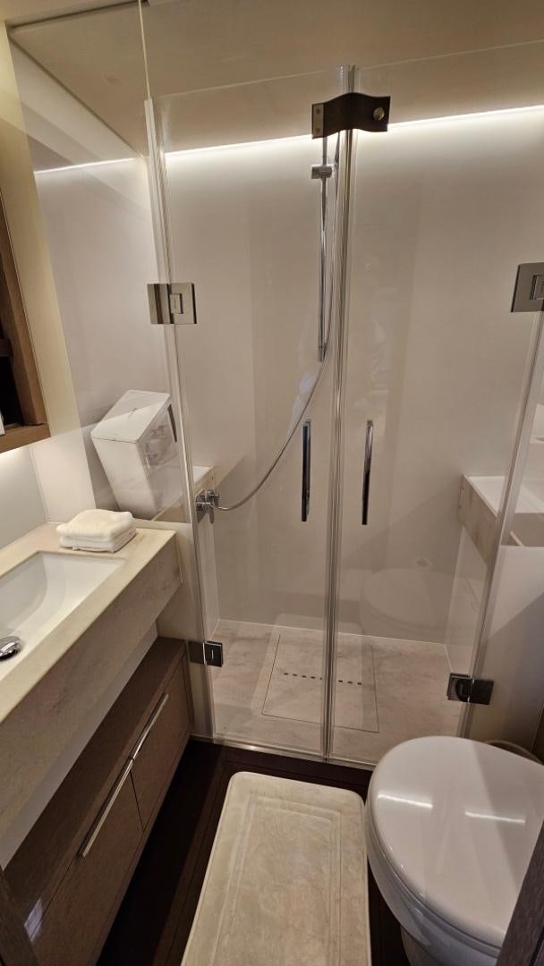 a bathroom with a shower unit and a toilet aboard SUNLOVE Yacht for Sale