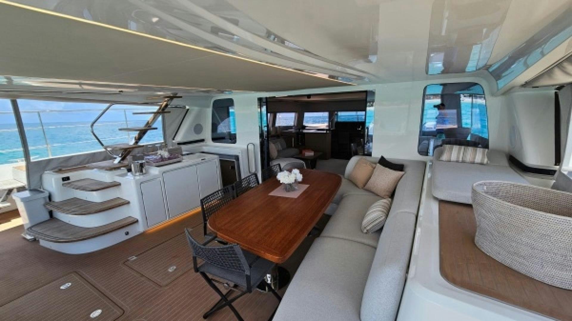 a room with a table and couches aboard SUNLOVE Yacht for Sale