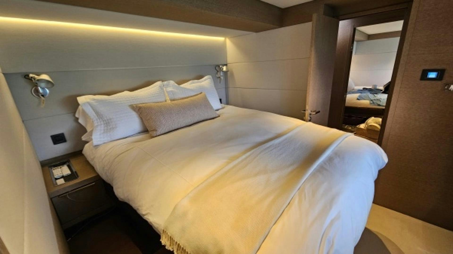 a bed with white sheets aboard SUNLOVE Yacht for Sale