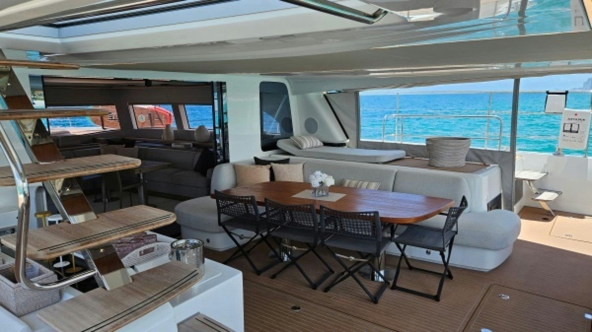 a room with tables and chairs aboard SUNLOVE Yacht for Sale