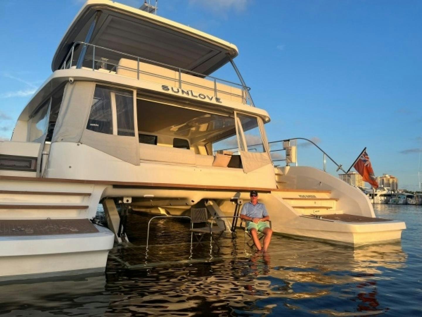a person standing next to a boat aboard SUNLOVE Yacht for Sale