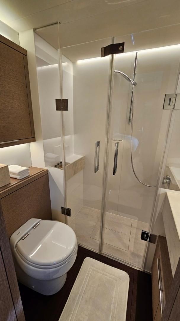 a bathroom with a glass shower aboard SUNLOVE Yacht for Sale