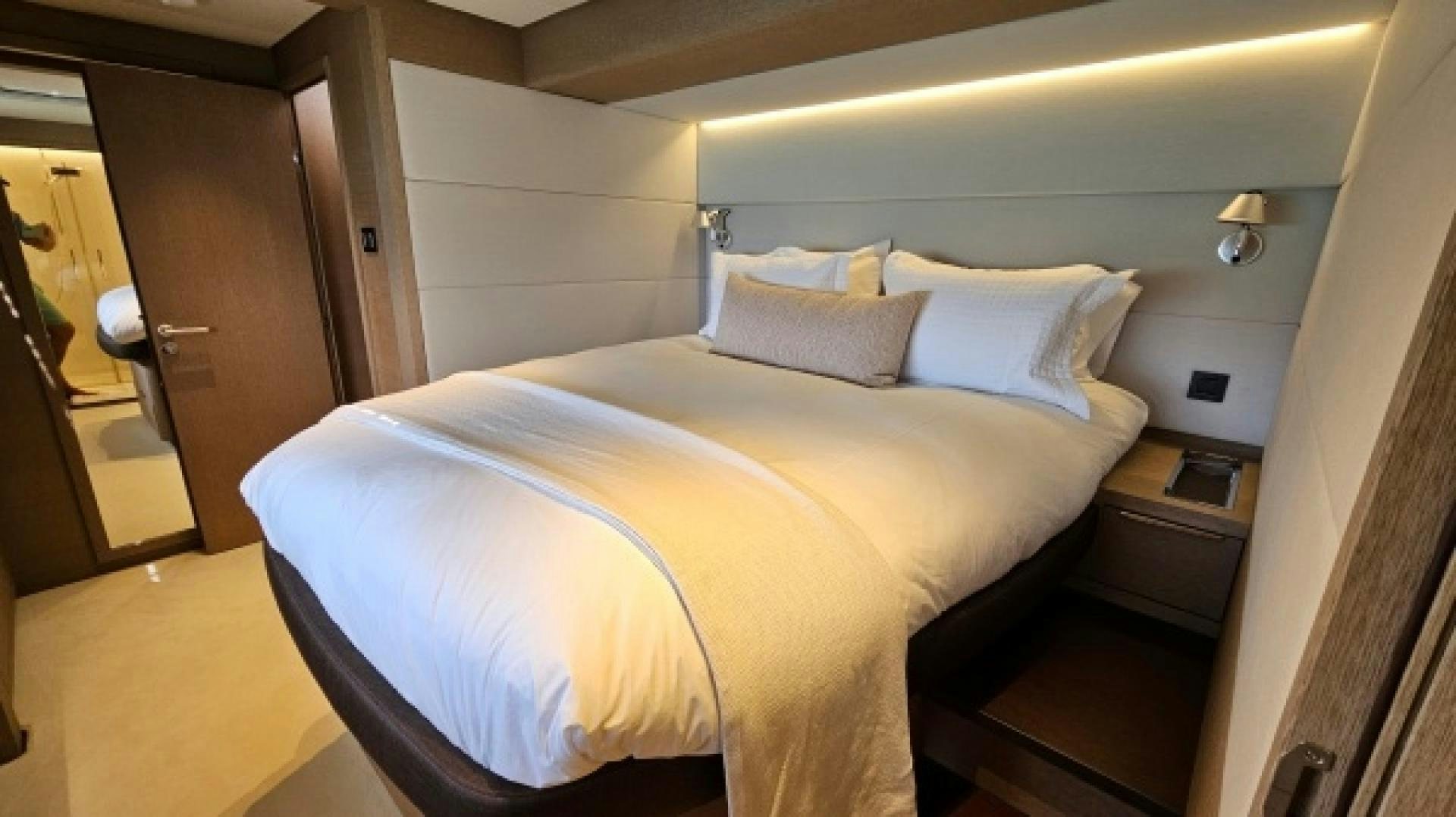 a bed with white sheets aboard SUNLOVE Yacht for Sale