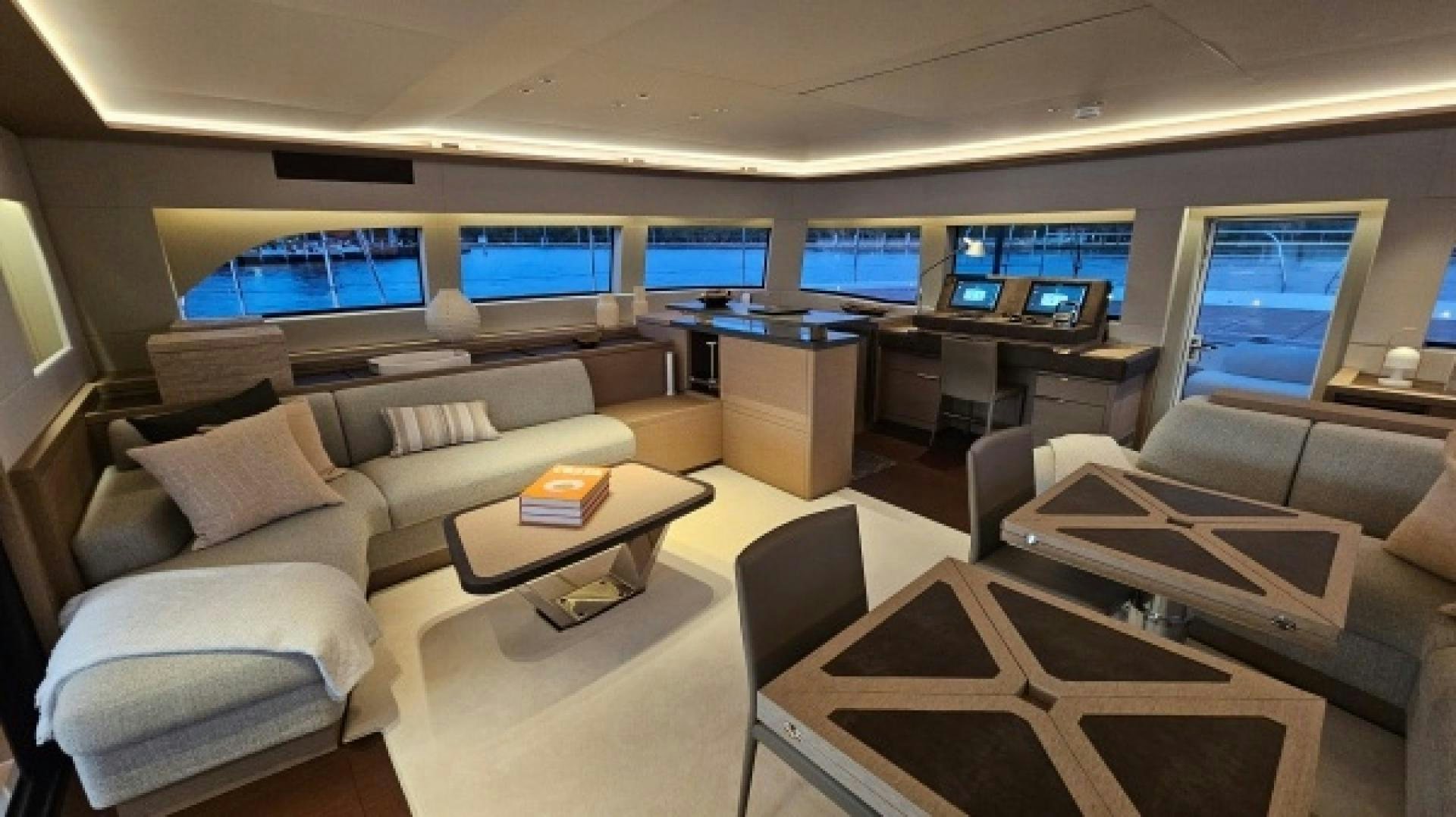a room with a couch and a table with a computer on it aboard SUNLOVE Yacht for Sale