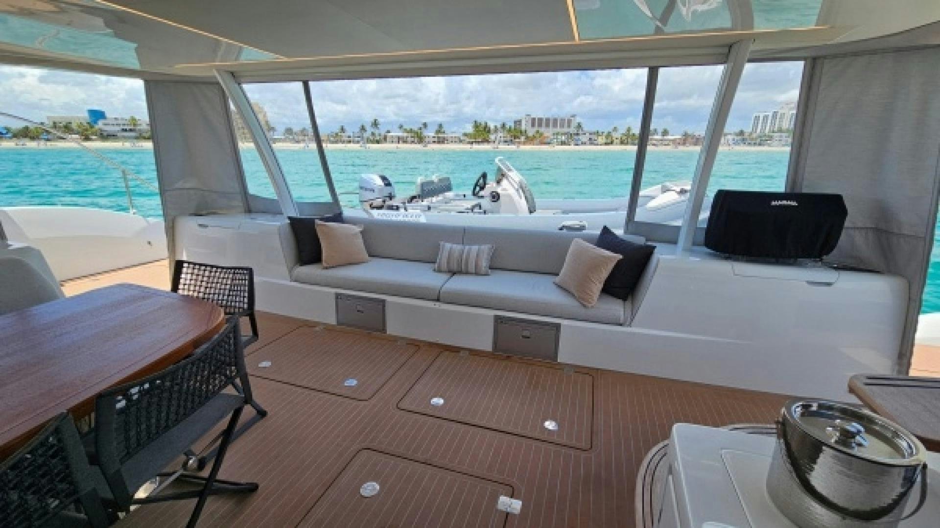 a room with a bed and a table and chairs aboard SUNLOVE Yacht for Sale