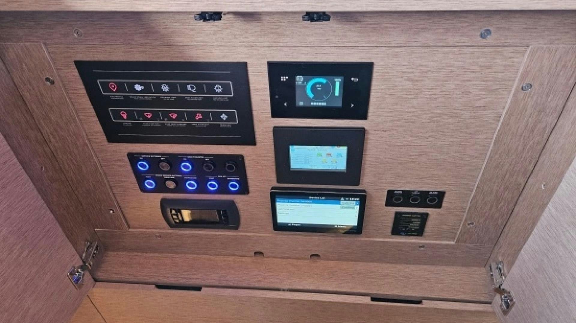 a group of electronic devices on a wooden table aboard SUNLOVE Yacht for Sale