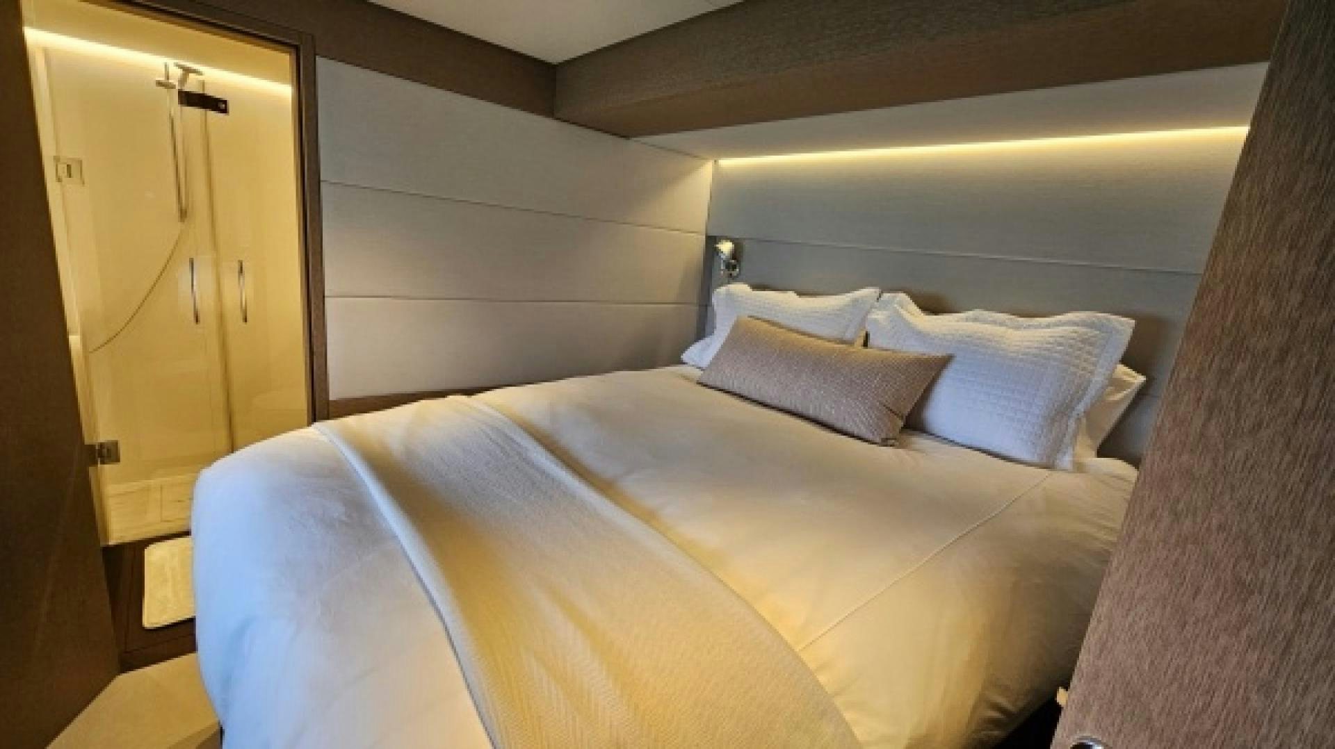 a bed with a yellow sheet aboard SUNLOVE Yacht for Sale
