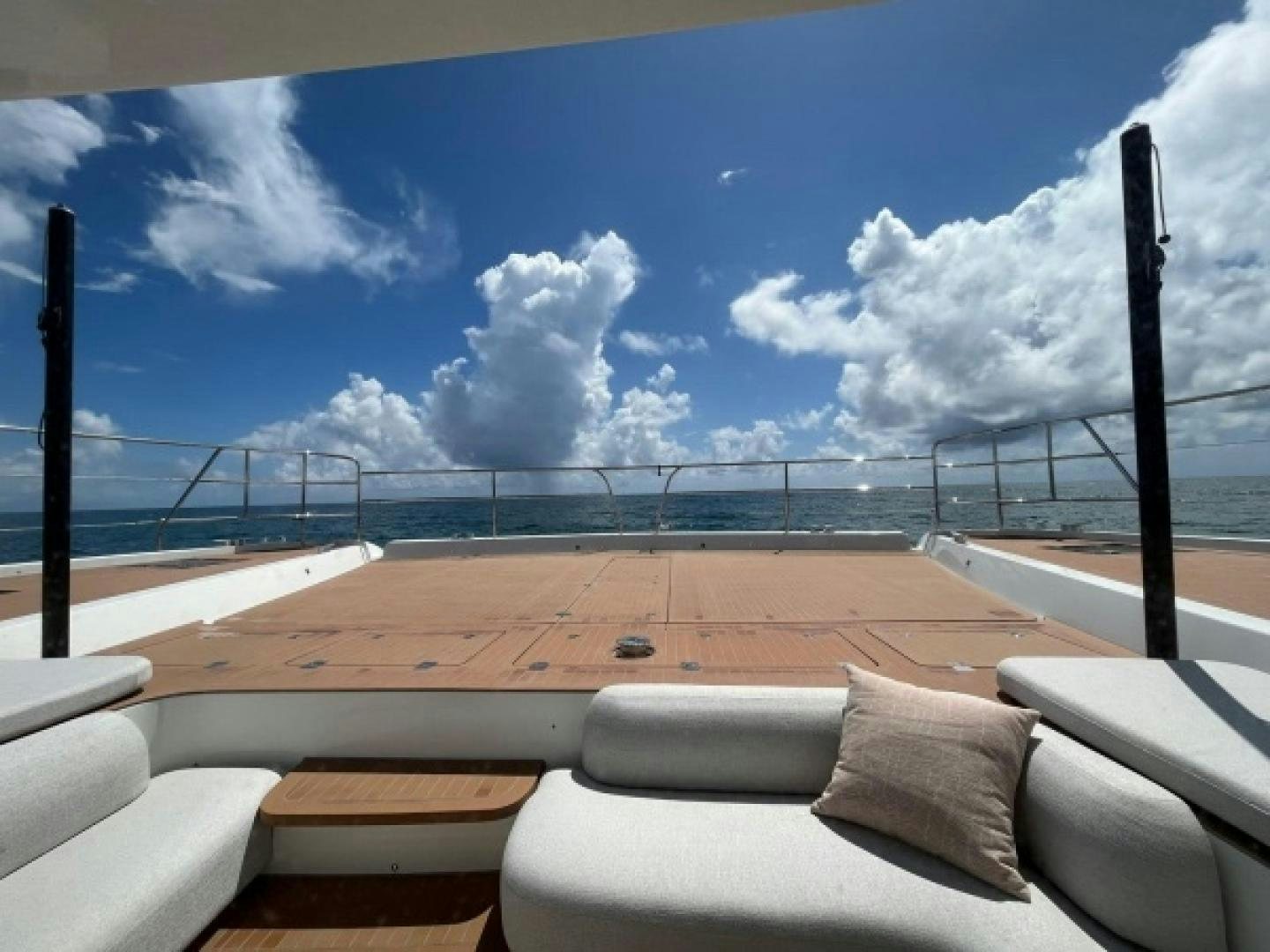 a lounge chair on a deck overlooking the ocean aboard SUNLOVE Yacht for Sale