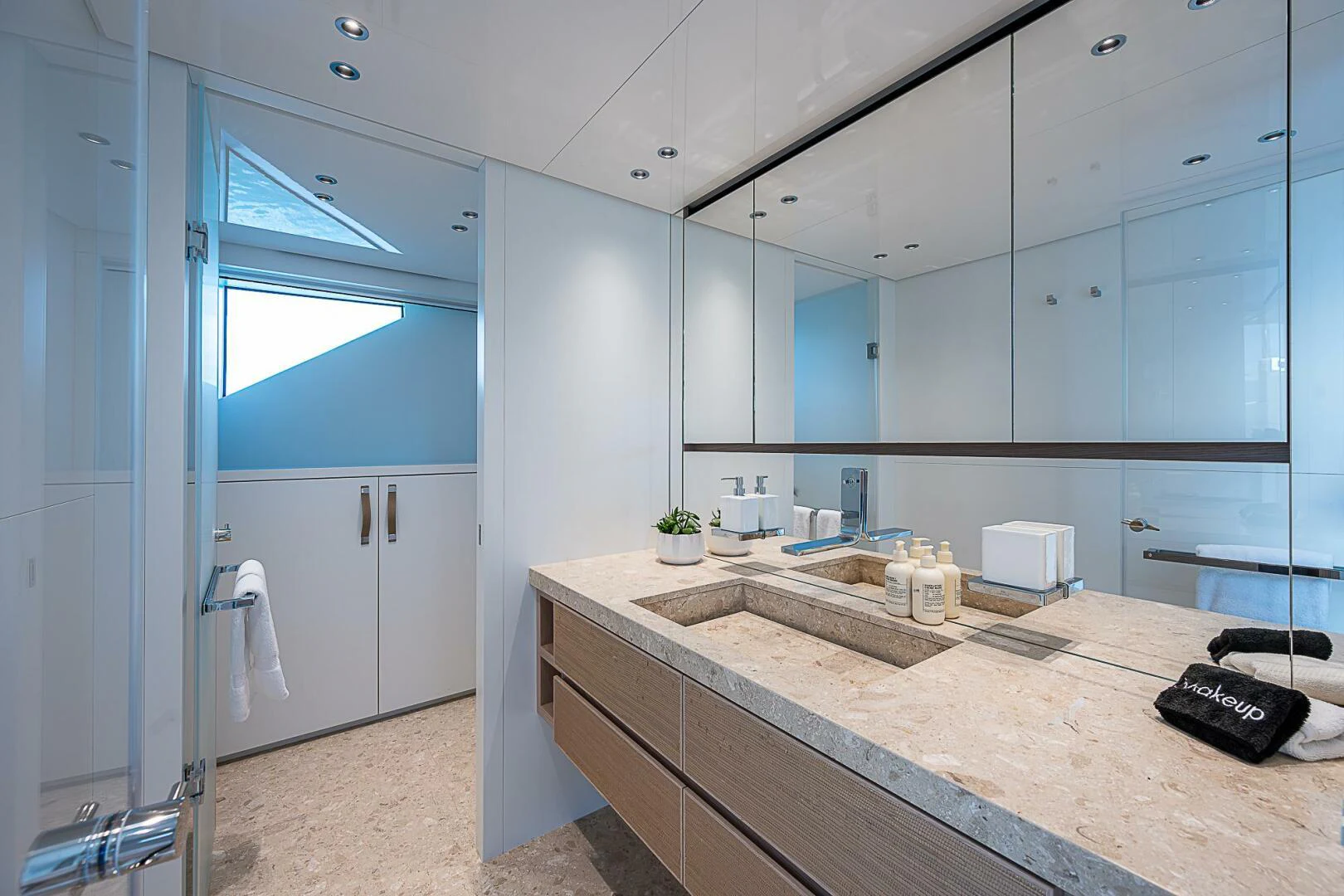 a bathroom with a countertop sink and a large mirror aboard F 118 Yacht for Sale