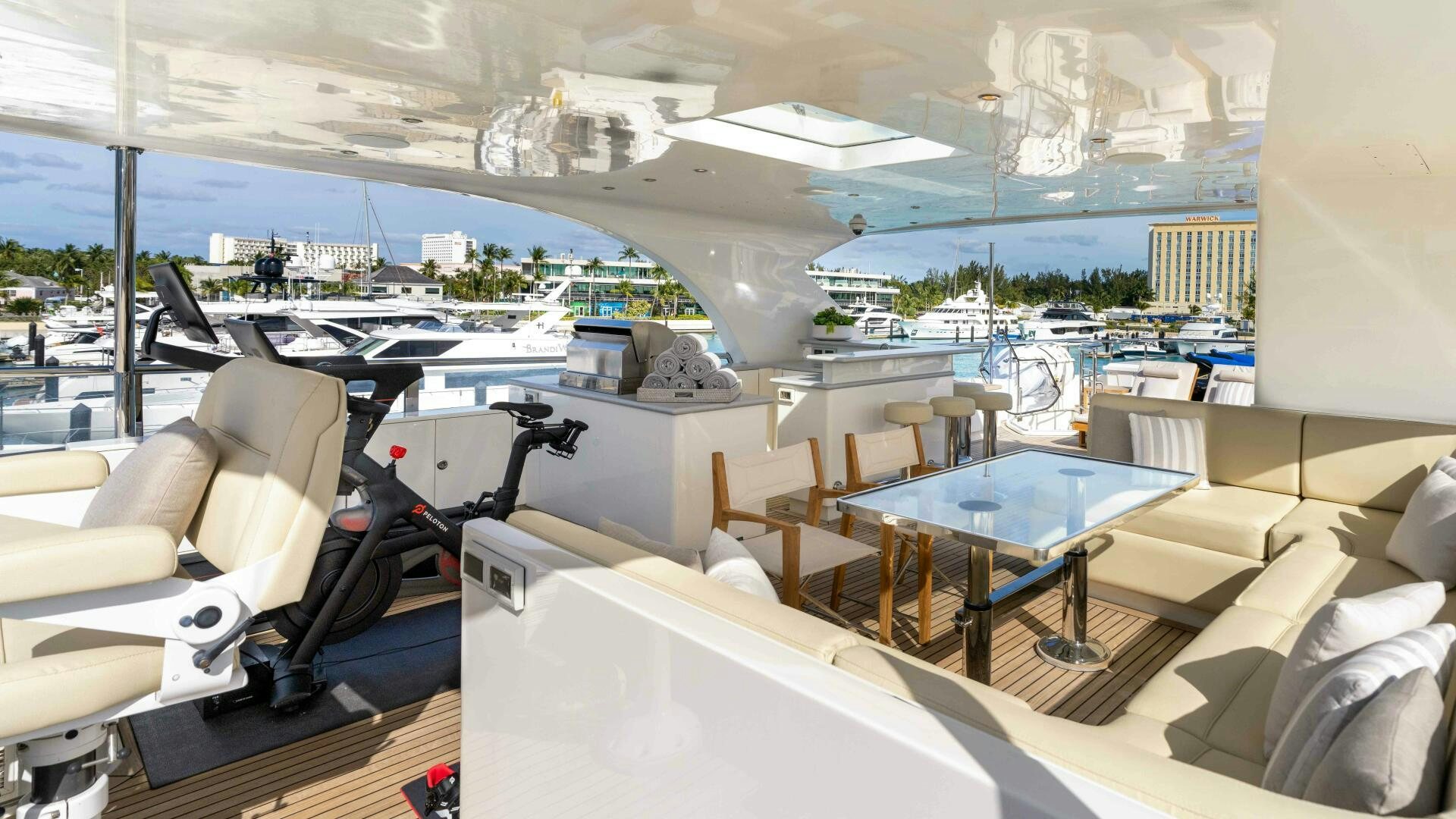 a room with a table chairs and a view of the water aboard STAY SALTY Yacht for Sale