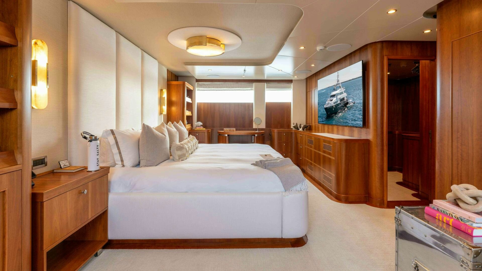 a bedroom with a bed and a desk aboard STAY SALTY Yacht for Sale