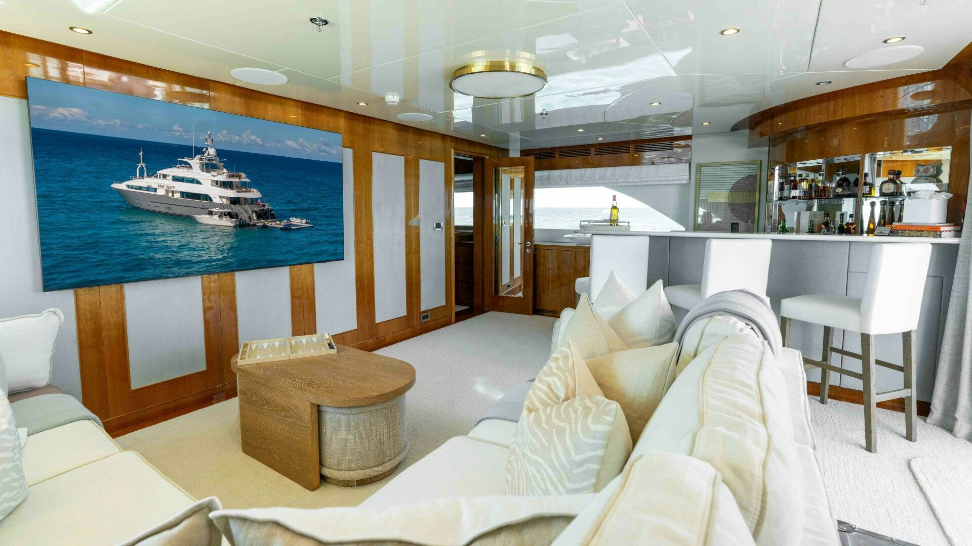 a large living room with a large blue screen aboard STAY SALTY Yacht for Sale