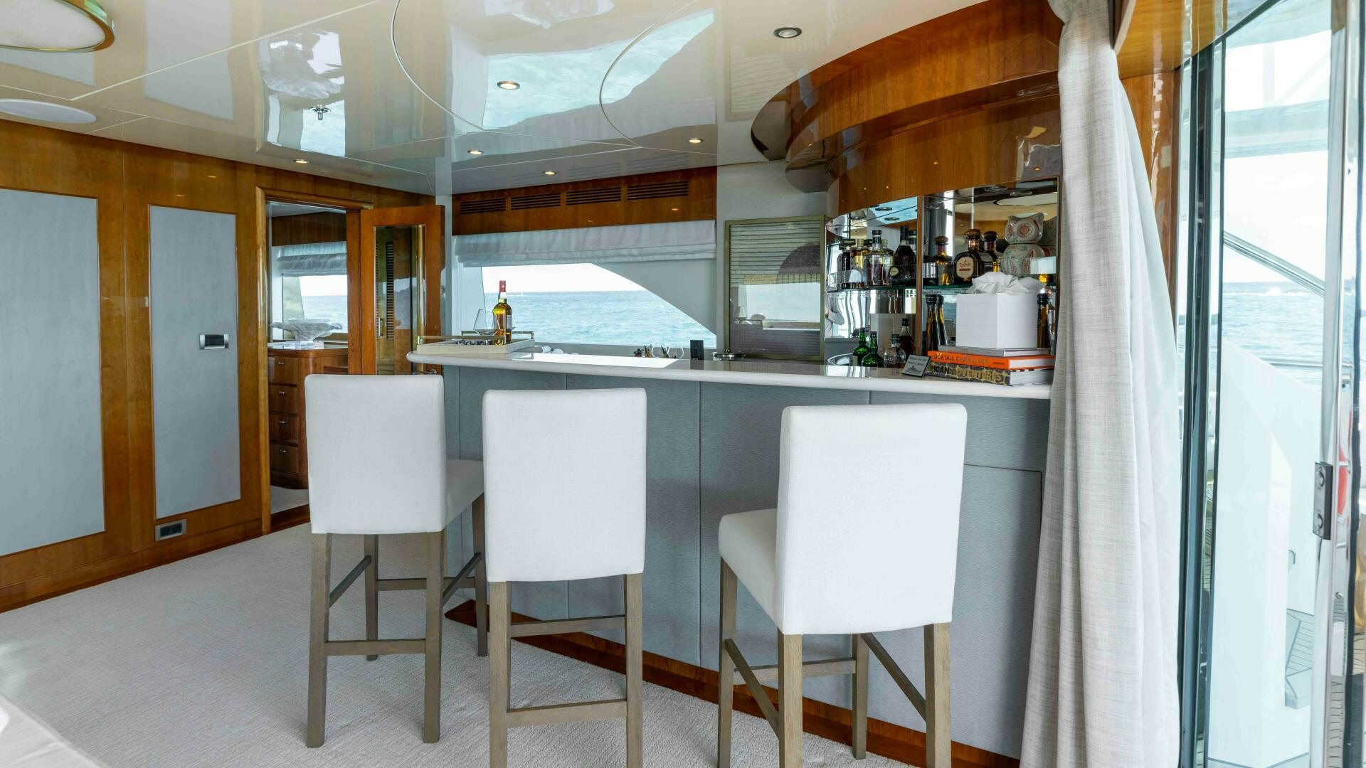 a kitchen with white chairs aboard STAY SALTY Yacht for Sale