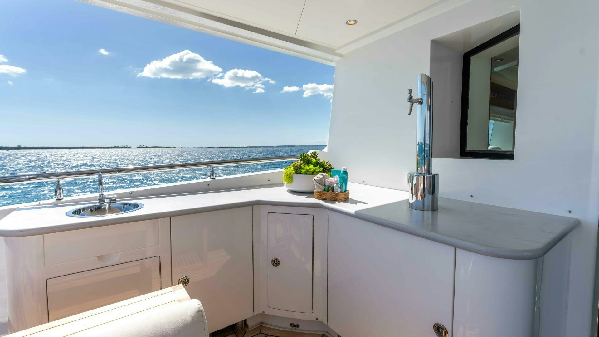 a kitchen with a large window aboard STAY SALTY Yacht for Sale