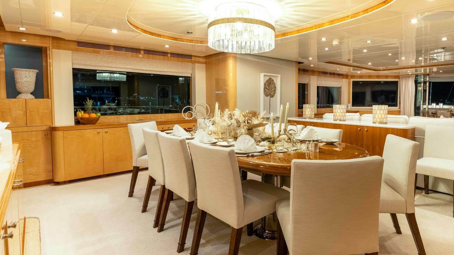 a large dining room with white chairs aboard STAY SALTY Yacht for Sale