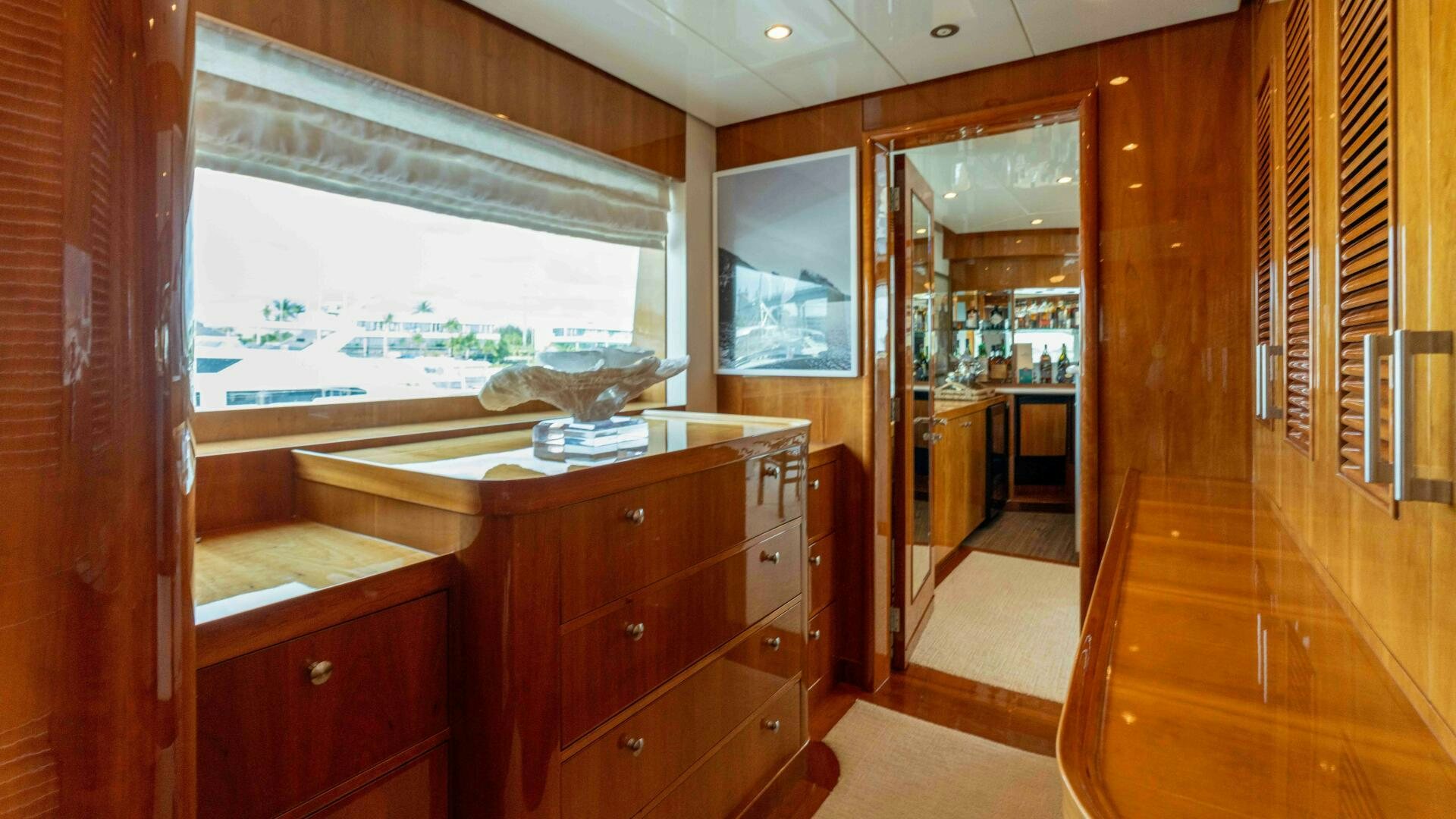 a room with a wood door and a wood cabinet and a window aboard STAY SALTY Yacht for Sale